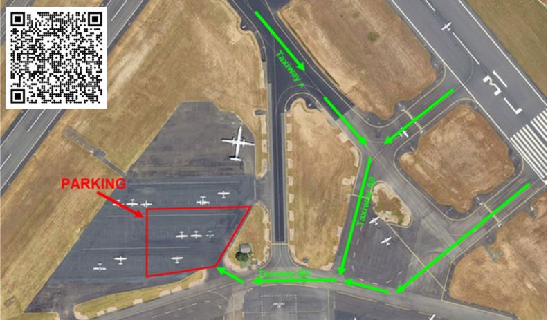 Aerial map of Hillsboro Airport showing green taxi arrows guiding aircraft to a designated fly-in parking area highlighted in red.